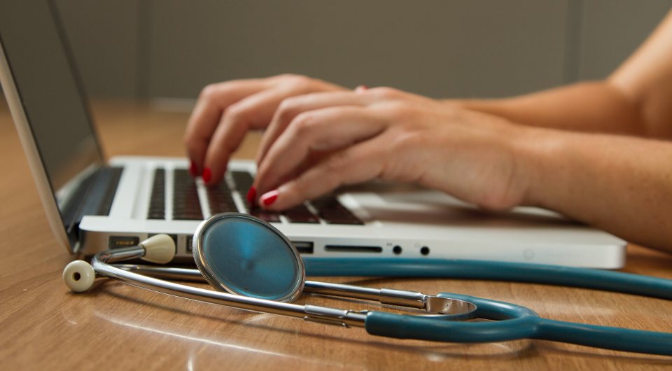 Photo of a doctor and her laptop by National Cancer Institute on Unsplash