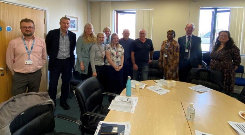 Image of attendees at meeting to discuss reducing harm caused by opioids.