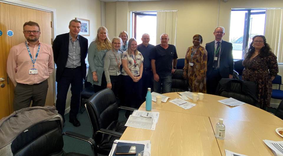 Image of attendees at meeting to discuss reducing harm caused by opioids.