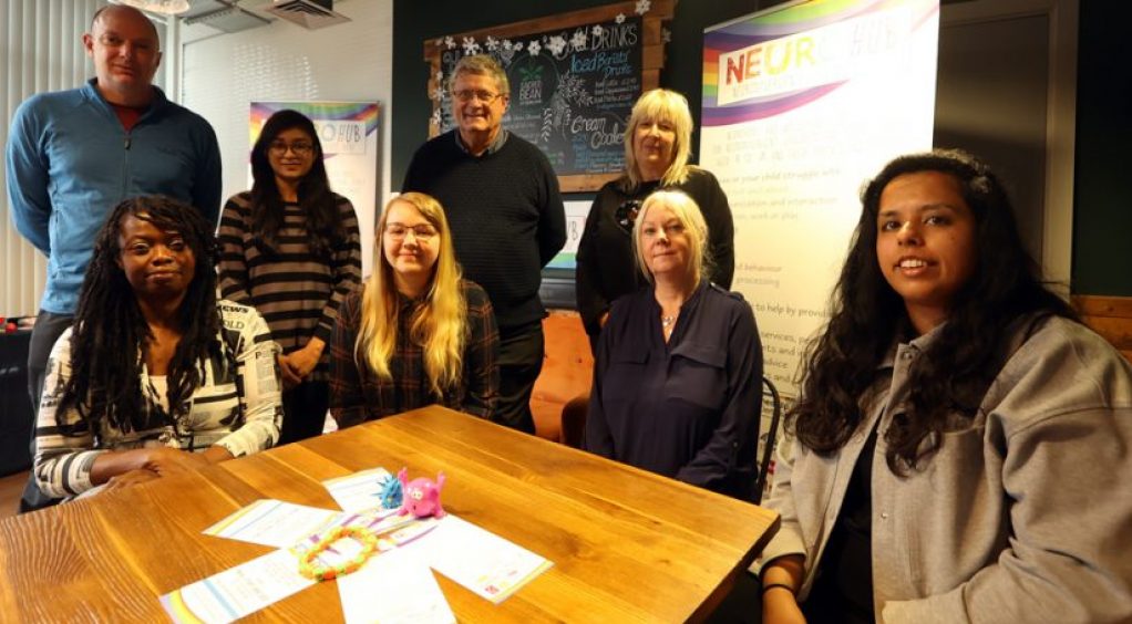 a group of people sitting and standing together